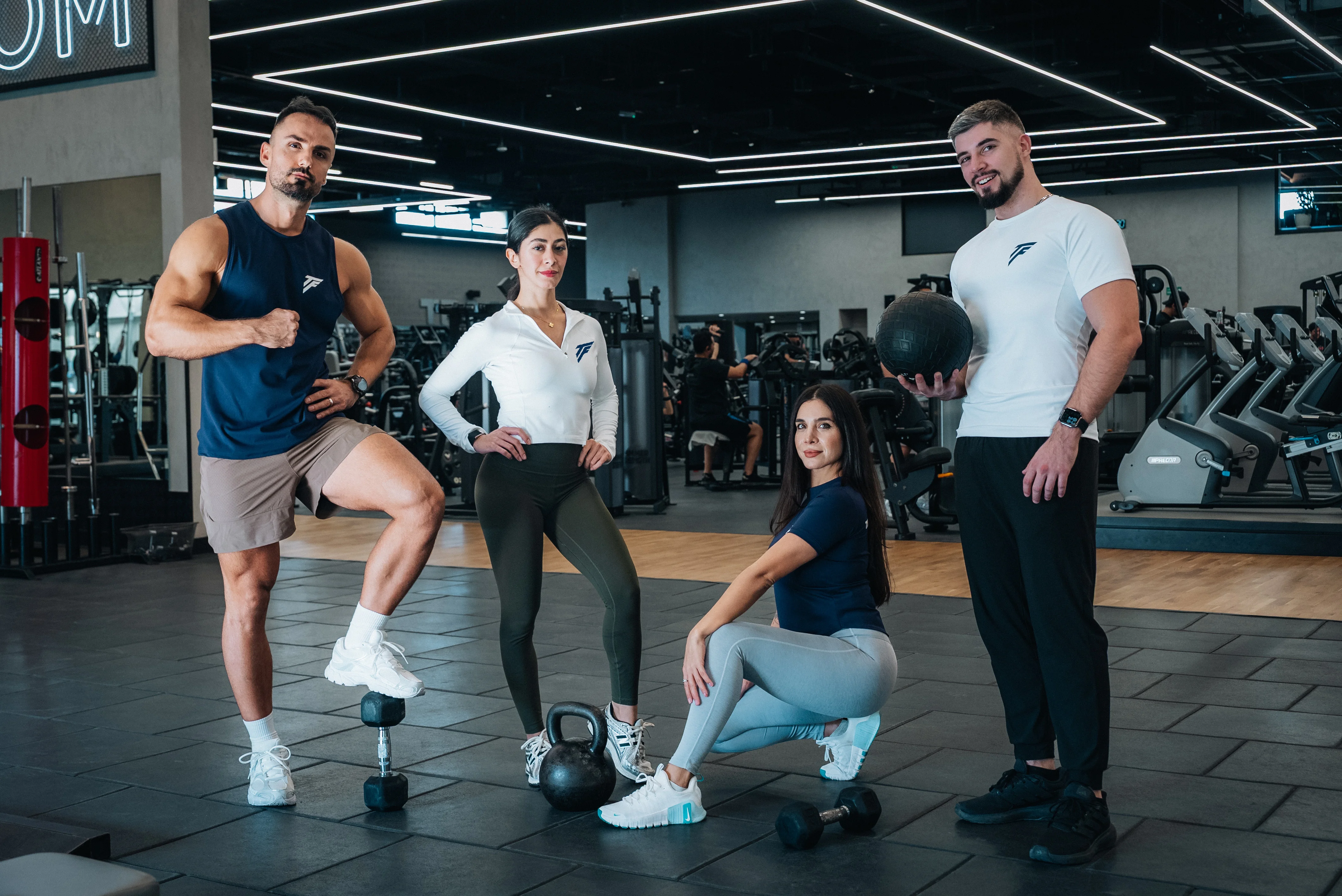 Personal trainer guiding a client in-gym with correct technique and coaching cues